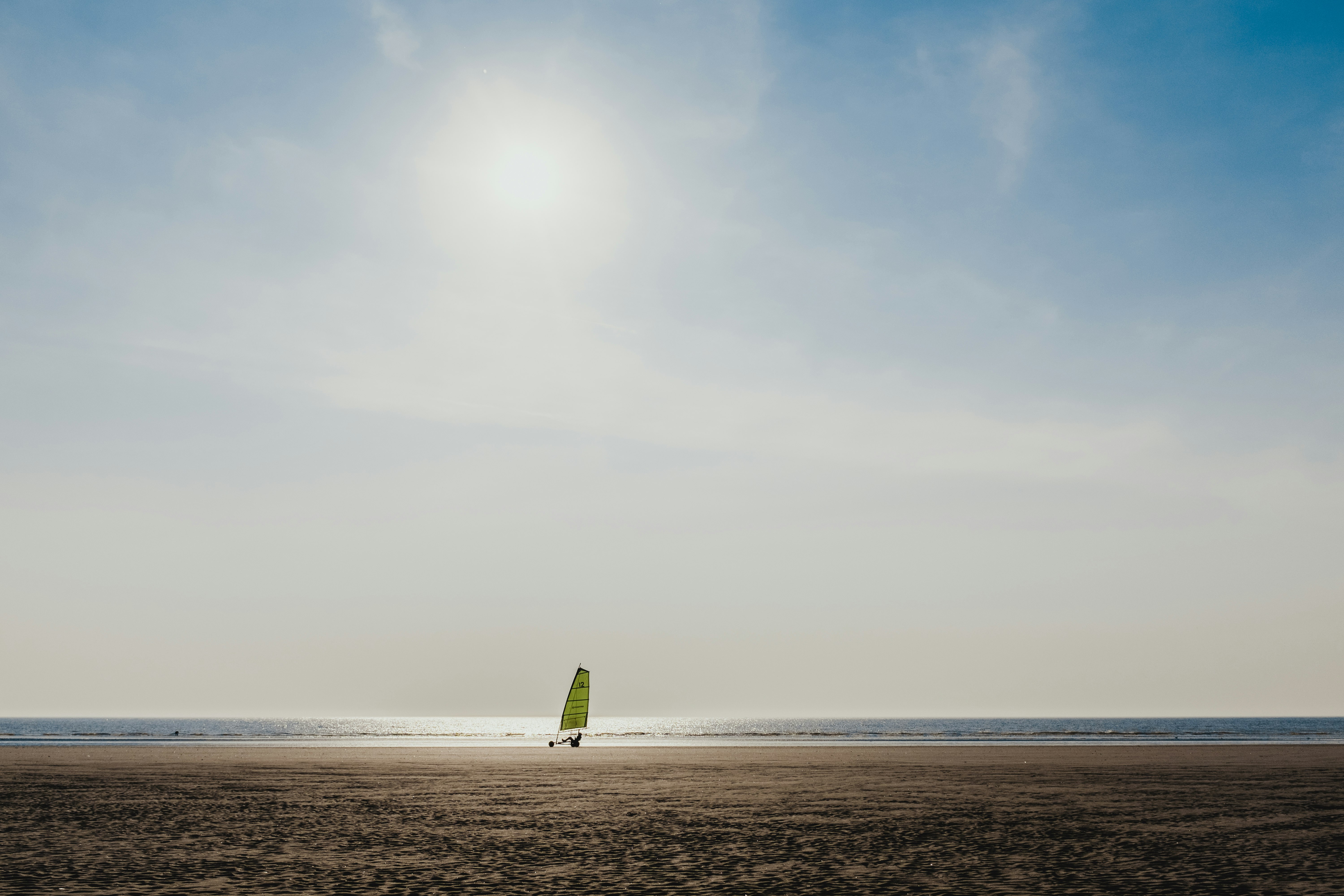 green sailboat on sea during daytime